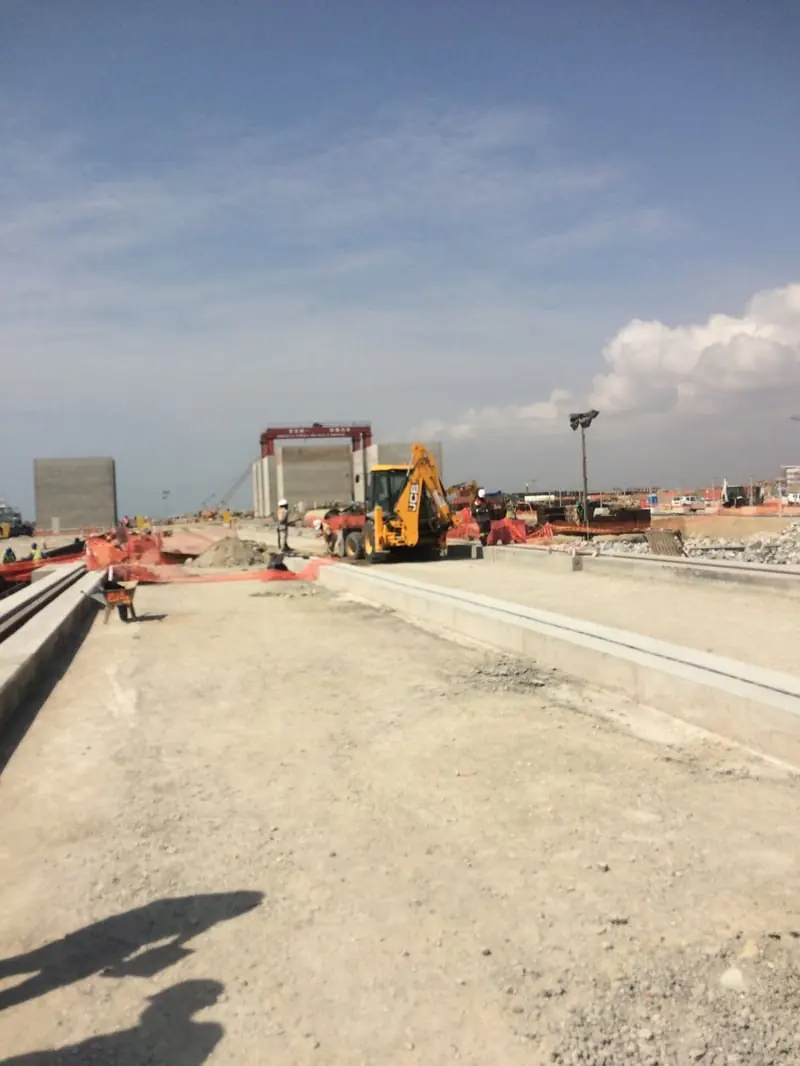 Port infrastructure construction site at the Port of Tema, Ghana, with heavy plant and concrete works in progress.